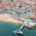 The beach, promenade and pier in the centre of Cascais from above