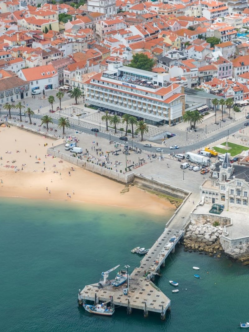 The beach, promenade and pier in the centre of Cascais from above