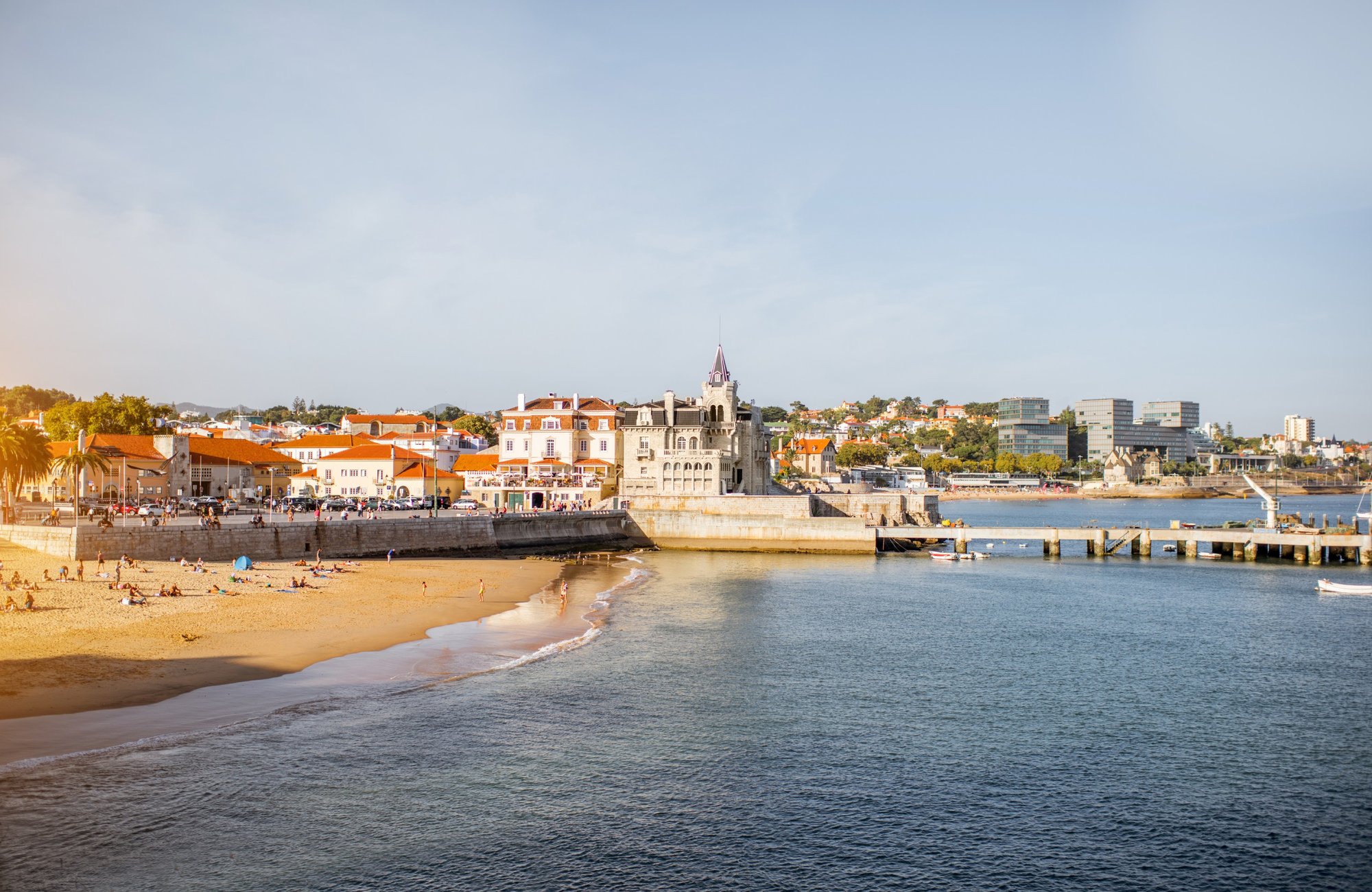 Golden evening light over the beach and bay at Cascais