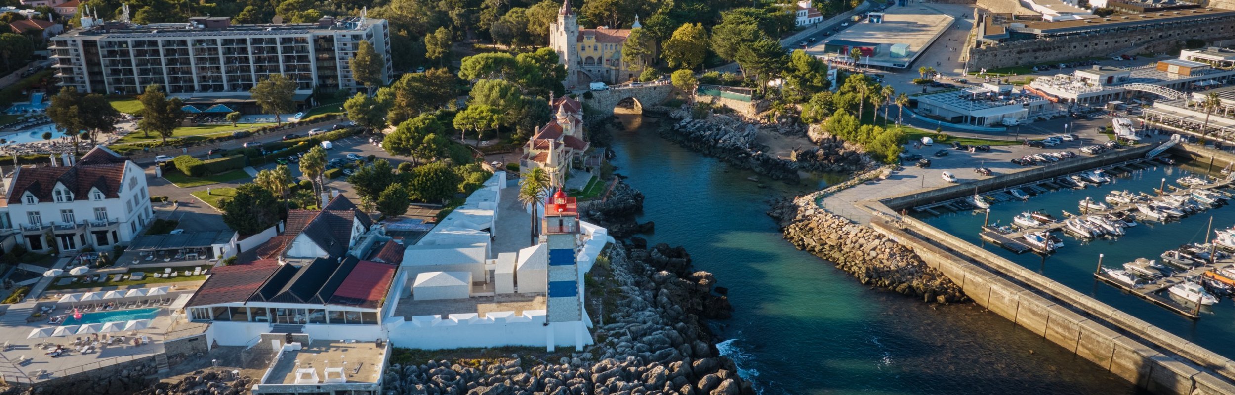 The Cascais headland, marina and lighthouse in the late afternoon