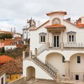 A white villa with painted azulejo panels above the rooftops of Sintra